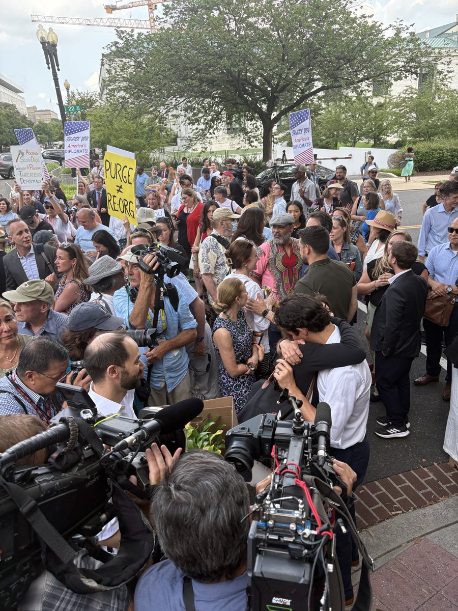 ebazaileimil's tweet image. Emotional scenes outside the State Department today as employees affected by a sweeping reduction in force leave the building. Current employees and supporters have lined up to “clap out” departing State Department staff at the department’s HQ in Foggy Bottom.