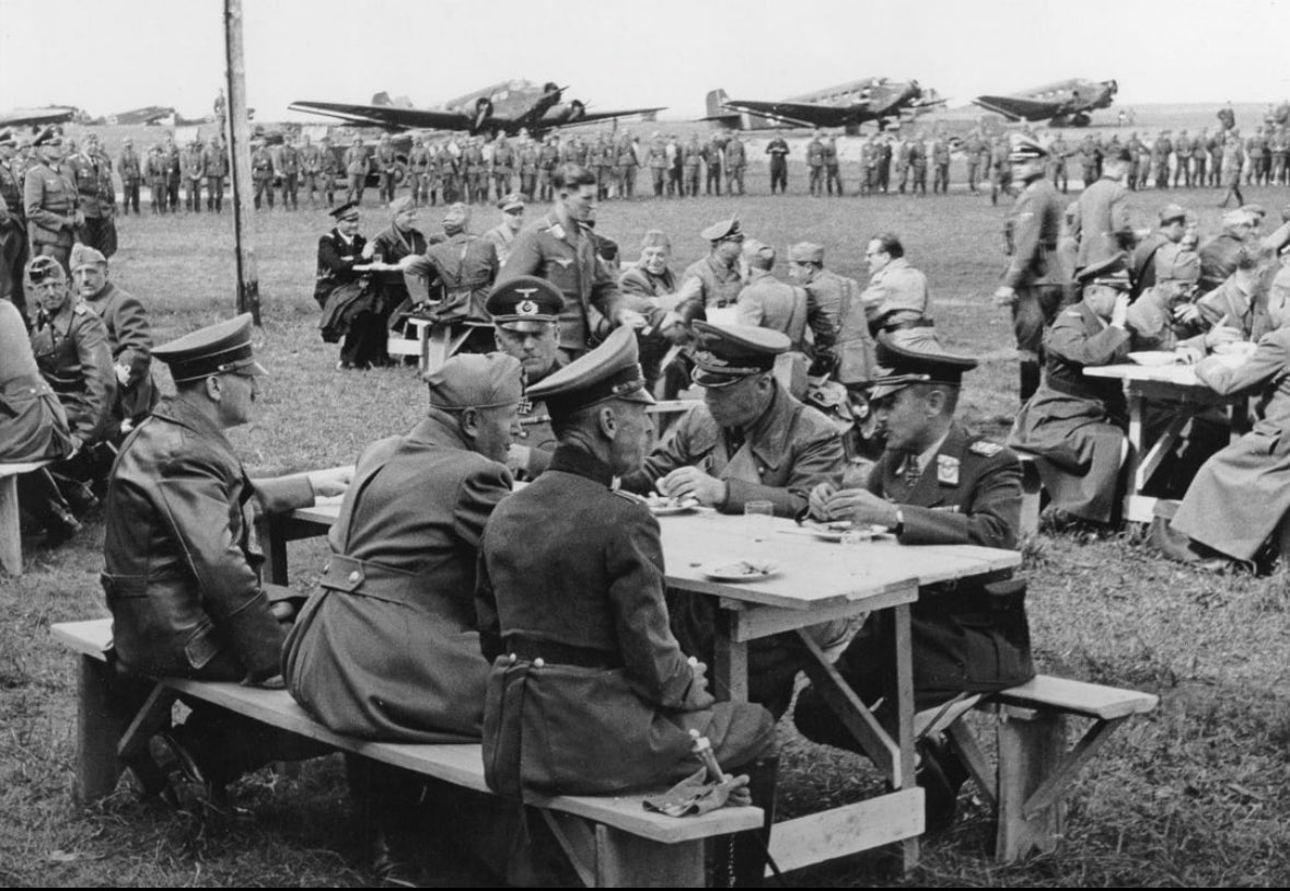 Adolf Hitler and Benito Mussolini visiting troops on the Eastern Front in Ukraine, 1941. In the photo, they are having a picnic.
