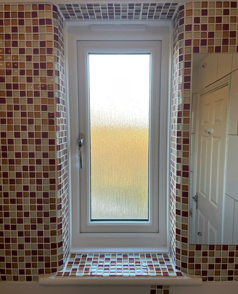 This beautifully fitted window is set back nicely in a mosaic-style bathroom, letting in all the light you need.