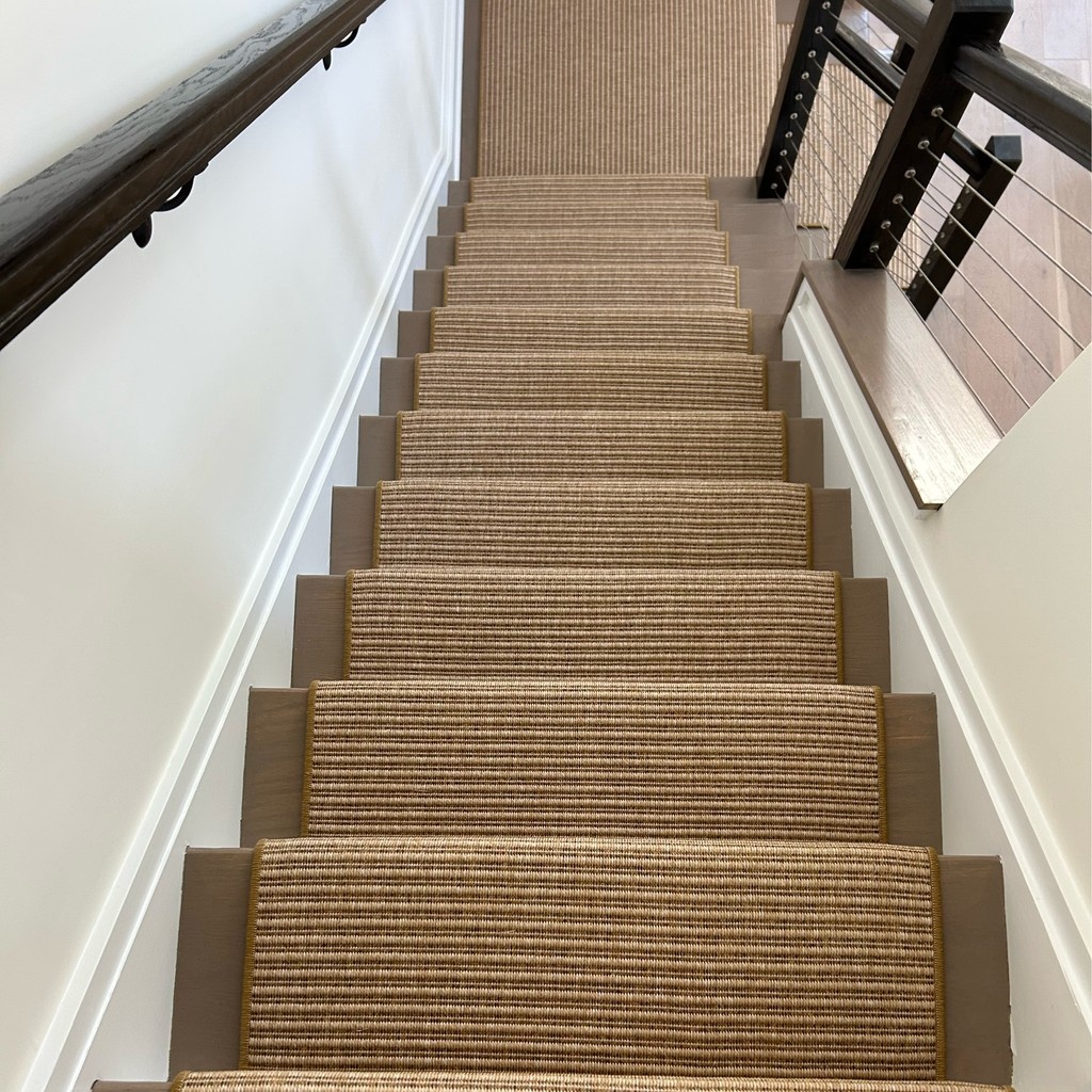 Coastal chic meets durability in this representation of our Antigua carpet design in a custom stair runner, expertly fabricated and installed by The Carpet Workroom. Woven to last and stylish to boot! 

⁠Click the link to order samples: l8r.it/IQoJ

⁠#couristan
