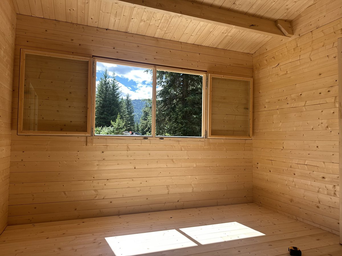 "Living the dream in my off-grid cabin! Nothing like waking up to mountains and fresh air—who needs curtains when you have a view like this? 🌄 #Grateful #OffGridLiving"