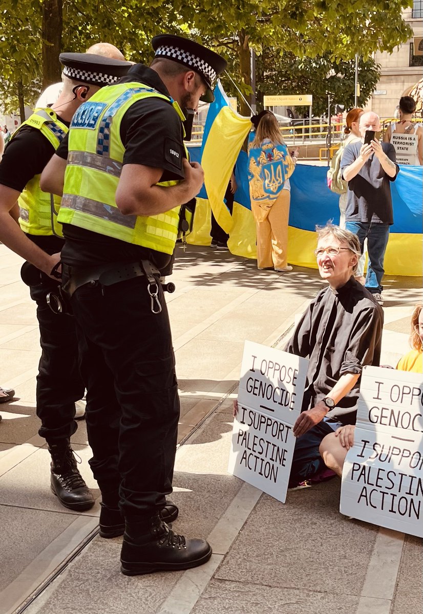 InvisibleMapper's tweet image. In Manchester police push through crowds + arrest 16 people inc 3 vicars and many elderly under the Terrorism Act for holding signs "I oppose genocide. I support Palestine Action"