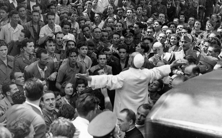 On this day in 1943, this iconic photograph was taken. In the morning of July 19th, American bombers targeted the working class district of San Lorenzo in Rome, killing 3,000 civilians. When the bombings stopped, Pius XII visited the area to pray with the frightened population.