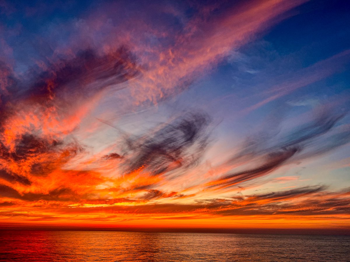 The sun dips low where sky meets sea,
A molten trail where dreams sail free.
Waves applaud the fading light,
Cradling day into the night. HAPPY SUNDAY