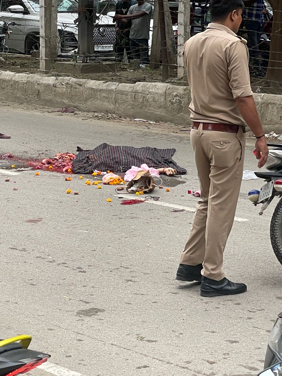 गौर सिटी-2 में महागुन मार्ट के सामने एक डंपर ने स्कूटी सवार महिला को कुचल दिया. महिला के बगल में बैग के साथ फूल बिखरे पड़े हैं. महिला पूजा करने जा रहीं थीं या फूल खरीदकर पूजा के लिए ले जा रहीं थीं नहीं पता. लेकिन सड़क के दोनों और अतिक्रमण इस कदर है कि इंसान पैदल भी ना निकल सके.