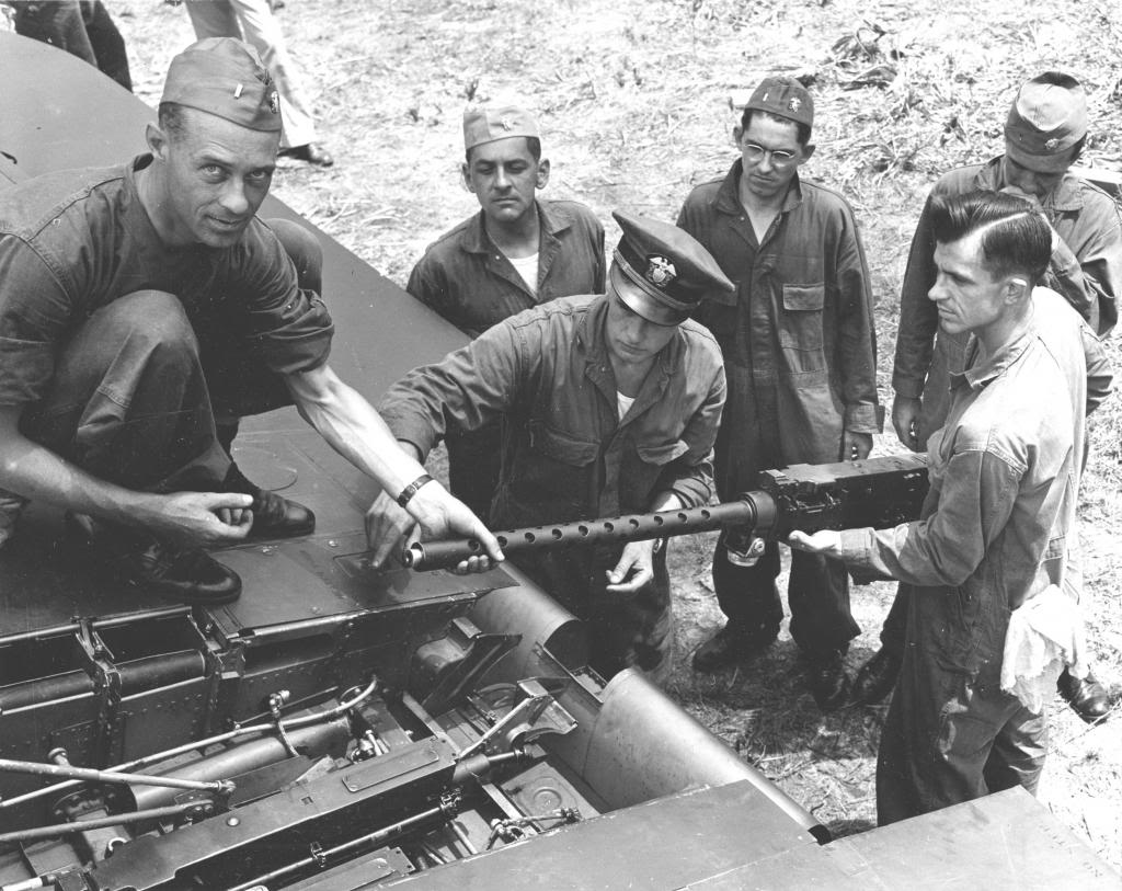 US Navy officers train in ordnance maintenance at Jacksonville, Florida, United States, Jul 12, 1944. In this case, they are installing a Browning M2 .50 caliber machine gun into the right wing of an F4U Corsair fighter.