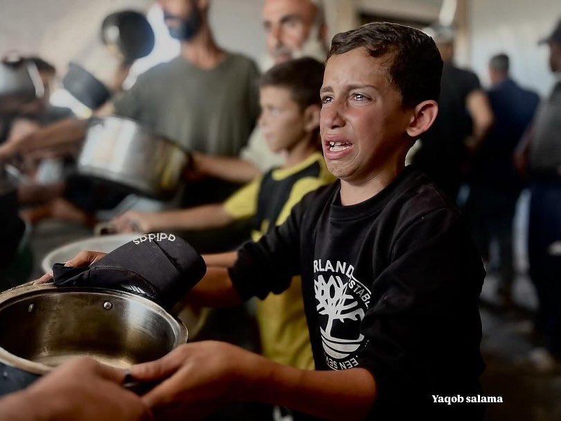 EyeonPalestine's tweet photo. A child breaks down in tears while trying to secure a meal in one of the aid distribution lines.

Amid blockade and famine, survival has become a daily battle, forcing children into a harsh fight for a single bite. https://t.co/aFqUzkA06F