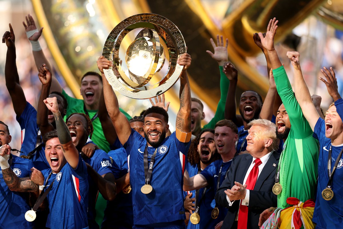 Reece James lifts the Club World Cup trophy... with President Donald Trump right in the thick of it.🏆