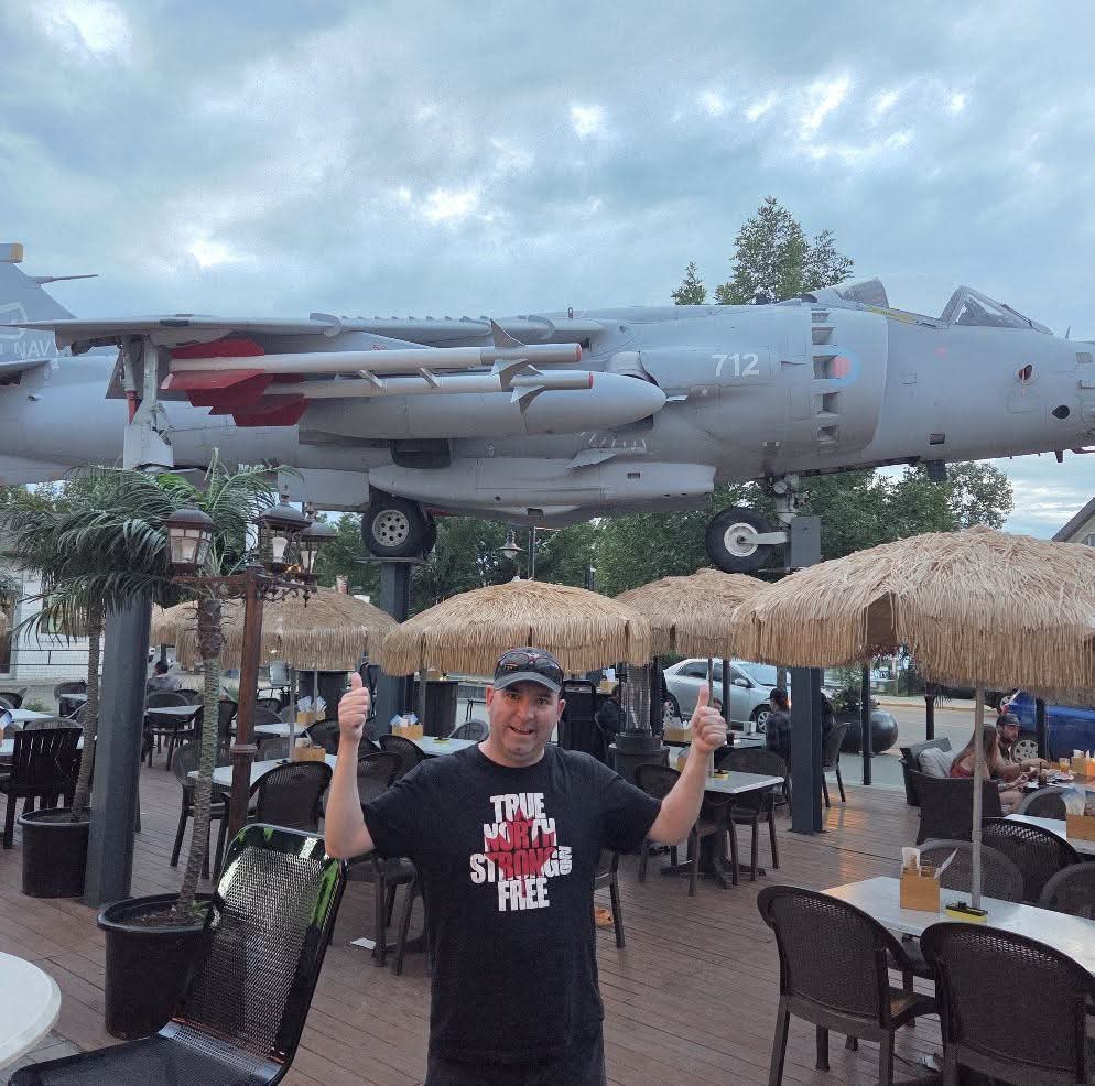 minion986's tweet photo. Have not posted in a while so here we are. At a patio bar that has a Harrier jump jet (GTA Hydra) sitting above everyone. Fucking awesome. I always loved the Harrier after seeing True Lies when i was a kid. 😀🛩 https://t.co/tyjI8sQyt1