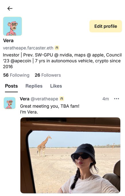 Vera posing in a vehicle with a giraffe in the background