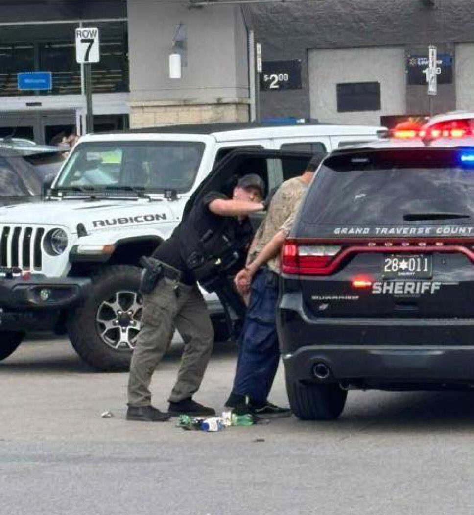 BREAKING - The first image has been released of the suspect in a mass stabbing at a Walmart in Grand Traverse County, Michigan, which left 11 victims, and it appears police quickly rushed him into their cruiser.