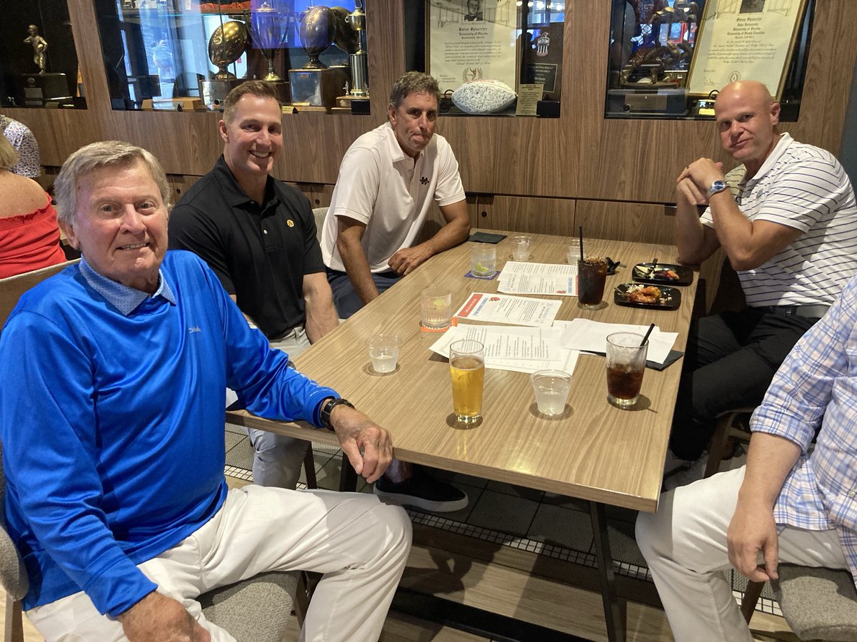 GeneFrenette's tweet image. When two @GatorsFB Heisman Trophy winners, a two-time SEC Player of the Year and a UF receiving legend/SEC Network star are seated at same table, u gotta snap the pic. My first time at Spurrier’s restaurant, didn’t know he had his own beer (Head Beer Coach) for consumption.