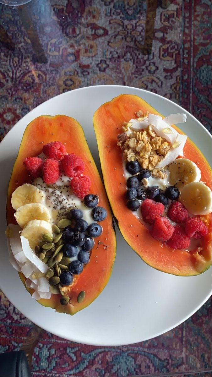 Fresh papaya in breakfast improve gut health and digestive acids papaya , Greek yogurt, raspberries, blueberries, shredded coconut with pumpkin seeds . #vegan #healthy #green #food #trending #nodrugs #nowar #cleaneating #trending