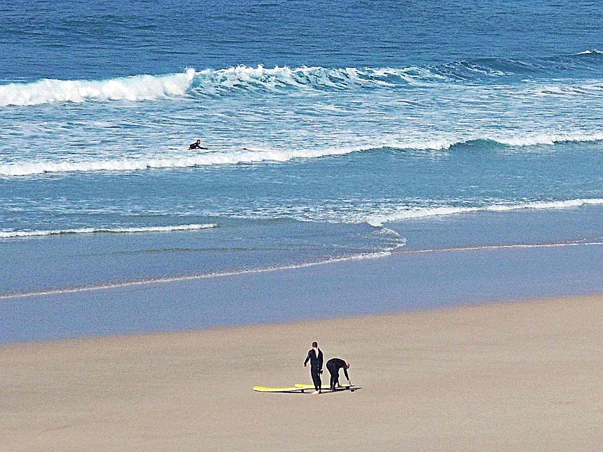 Surfing on a sunshine day at Newquay, Cornwall