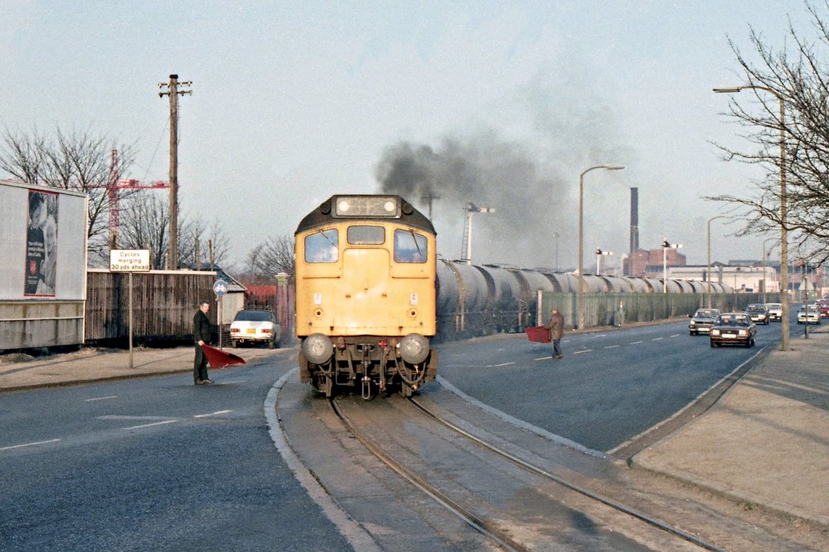 Nowt but a Lad (@nowtbutalad) on Twitter photo A British Rail Class 25 Diesel pulls an empty oil train across Stand Road #Preston some 40 years ago, heading up to the station and the West Coast Main Line; note the traffic ‘control’ - two men with red flags (and no HV vests). <a href="/blogpreston/">Blog Preston</a> <a href="/railnigel/">Nigel Harris</a> #Railways #Lancashire A British Rail Class 25 Diesel pulls an empty oil train across Stand Road #Preston some 40 years ago, heading up to the station and the West Coast Main Line; note the traffic ‘control’ - two men with red flags (and no HV vests). <a href="/blogpreston/">Blog Preston</a> <a href="/railnigel/">Nigel Harris</a> #Railways #Lancashire