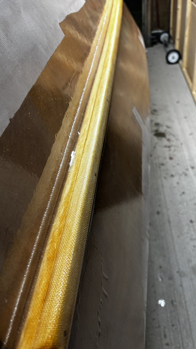 Applying fiberglass to the spray rails.