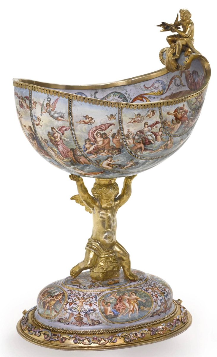 An Austrian silver-gilt and enamel shell-form compote (late 19th Century CE) -

The  shell-form body painted with classical figures in a seascape has at the centre of the bowl, Venus in a cartouche supported by mermaids and hippocamps, topped by a figure of Triton. Eight roundels