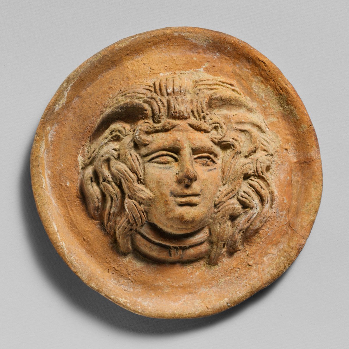 resclassicae's tweet image. Terracotta relief roundel with head of Medusa, Hellenistic, 2nd century BC, Metropolitan Museum of Art.