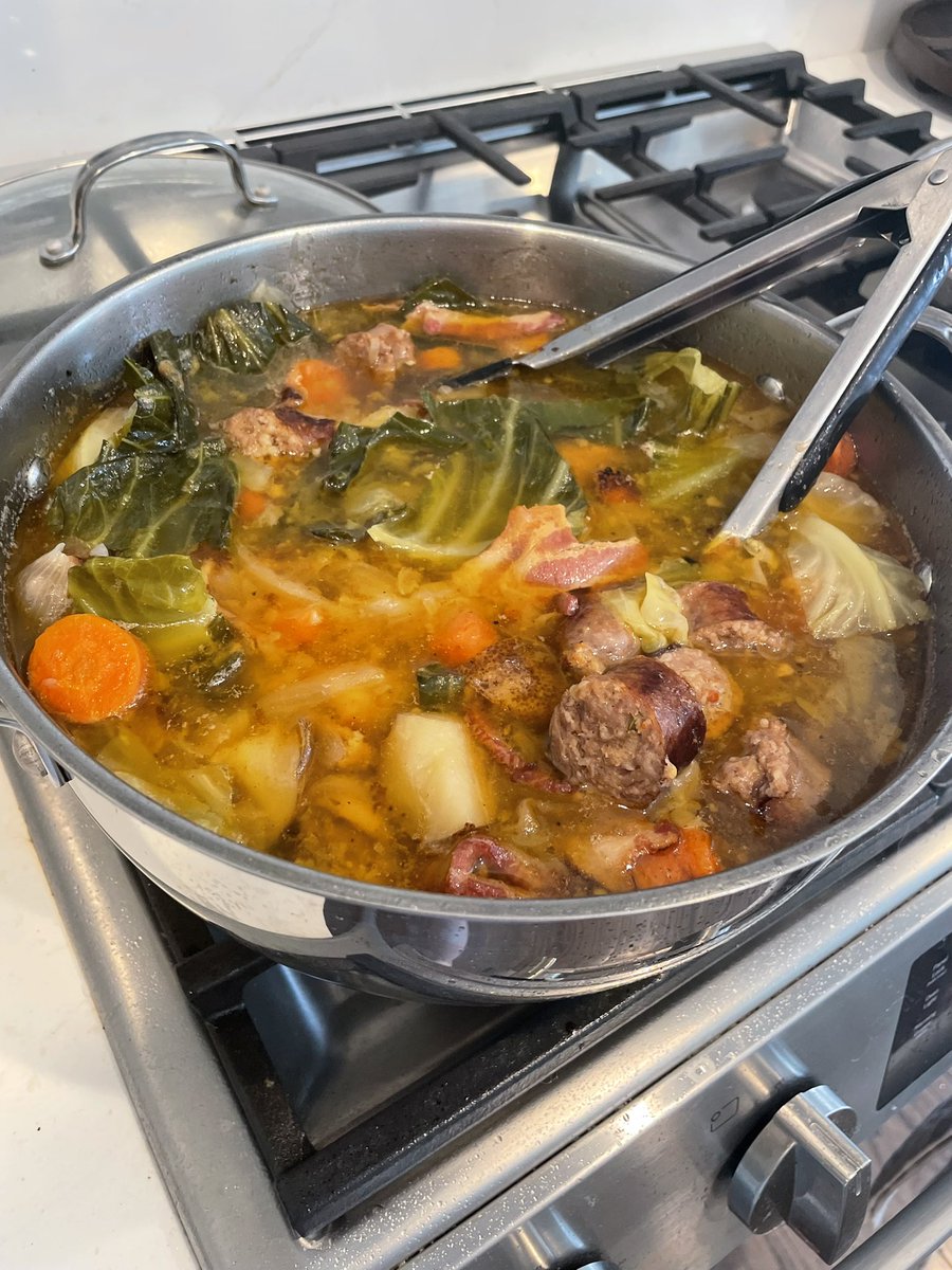 Pot au feu with cabbage, bacon, Italian sausages, onions, potatoes, and carrots