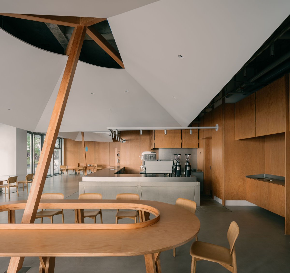 Archello's tweet photo. Atelier tao+c reimagines Blue Bottle Coffee at West Bund with floating timber canopies, Douglas fir joinery, and prefabricated concrete units that nod to the site’s industrial past. 
https://t.co/OmWqQnlkL0

#MaterialMemory #Prefabrication #UrbanCraft https://t.co/A4rx5BQKWn