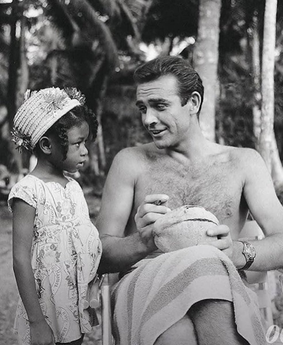 Sean Connery signing a coconut for a little Jamaican fan on the set of 

DR. NO (1962)