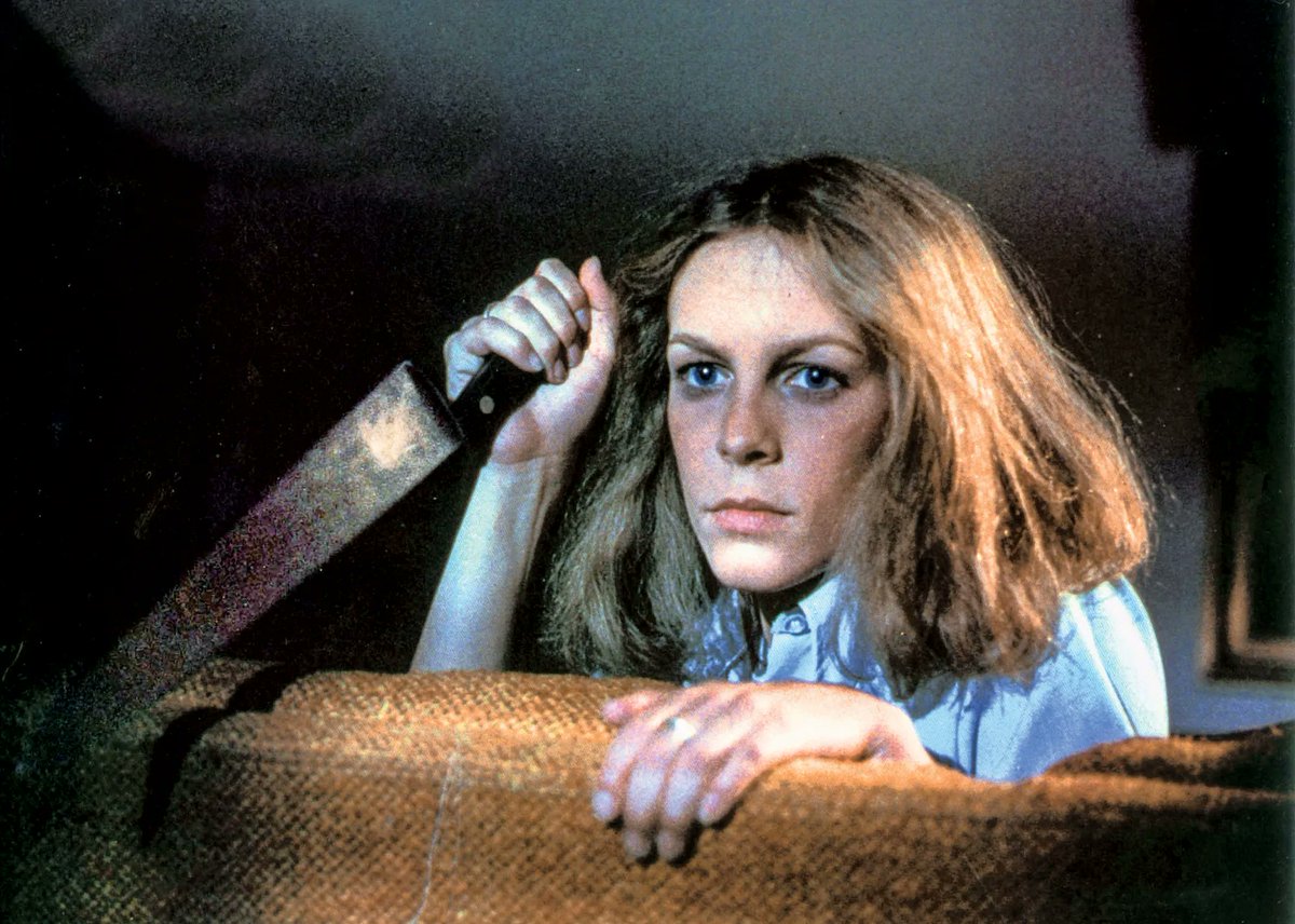 A Belated #TuesdayNightTerror Rises from the Grave...
While The Darkness waits for no one, it is sometimes fashionably late.This week’s terrifyingly overdue question is: Who is your favorite horror movie protagonist? Tell us who you cheer for when the blood starts flying and why.