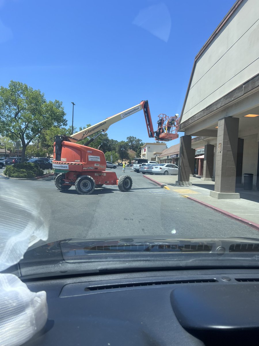 new @rossdressforless going in, workers are too stupid to use a lift or ladder so just block the entire parking lot, great work
