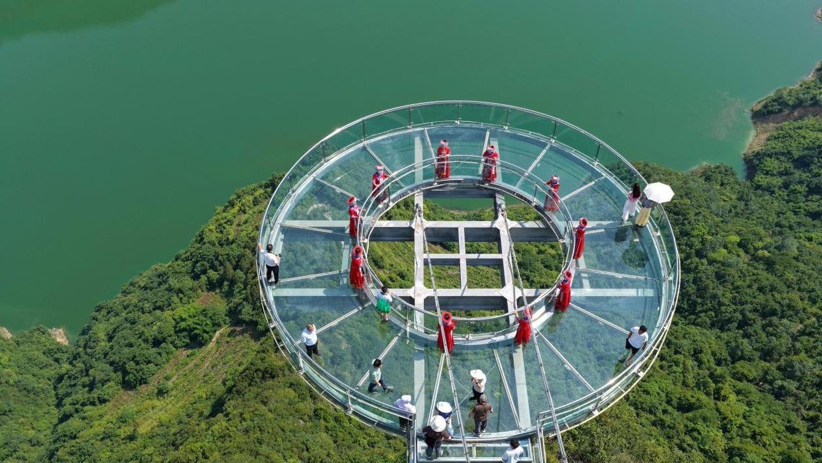 Tourists take in the natural beauty of Enshi Tujia and Miao Autonomous Prefecture, central China's Hubei Province. Known for its cool alpine climate, dramatic karst landscapes, and rich Tujia culture, Enshi has become a summer favorite with offerings from canyon treks to