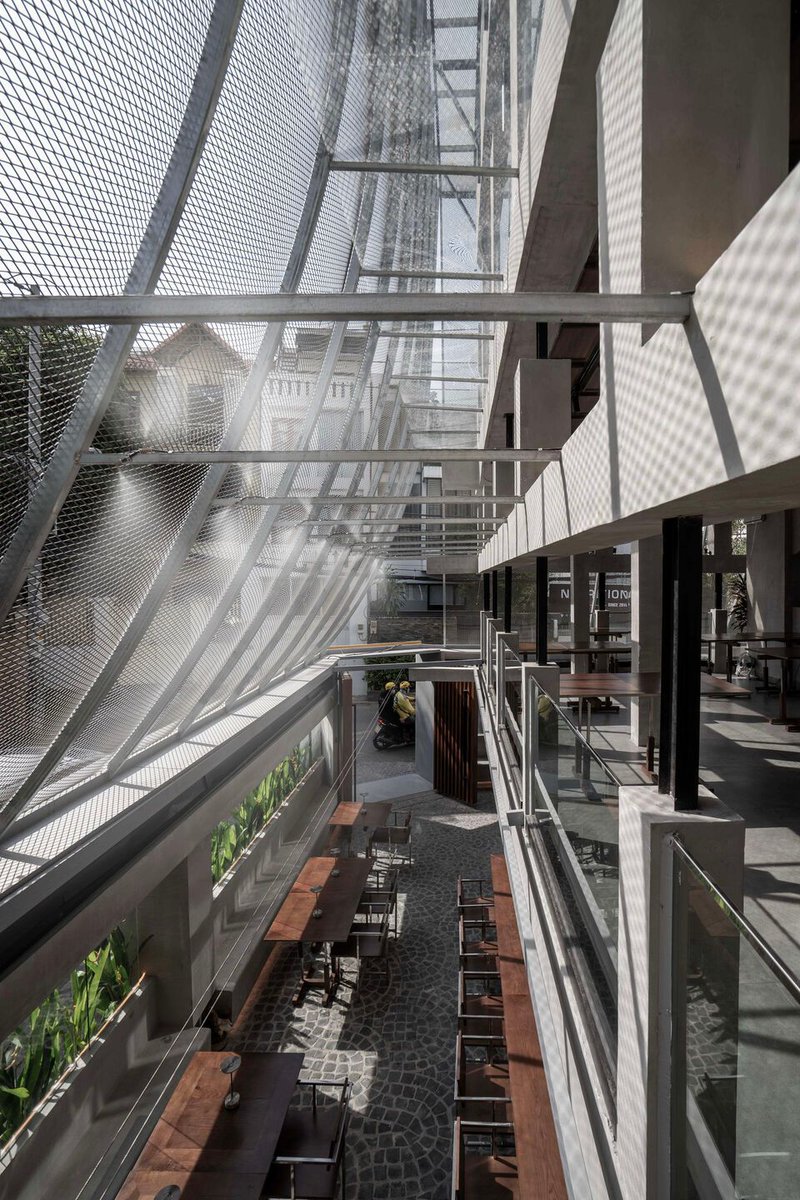Archello's tweet image. Studio KHOA VU transforms a Saigon villa with a porous metal mesh façade and low-impact methods. erates light, enhances ventilation, and creates a breathable buffer between private space and the tropical city. 
buff.ly/ZWnUnkN 

#LowImpactDesign #MaterialReuse