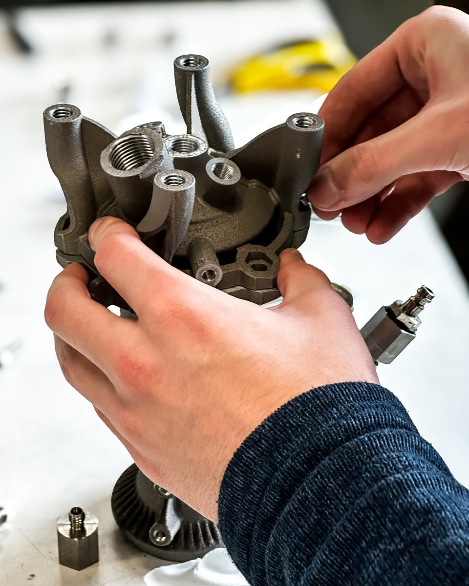 leap_71's tweet image. Assembling a 1.5kN thruster at the test stand. Like all of our rocket engines, this one was created from the same shared DNA, encoded in the Noyron Large Computational Engineering Model. The regen-cooled Kerolox engine was generated without human intervention and 3D printed.