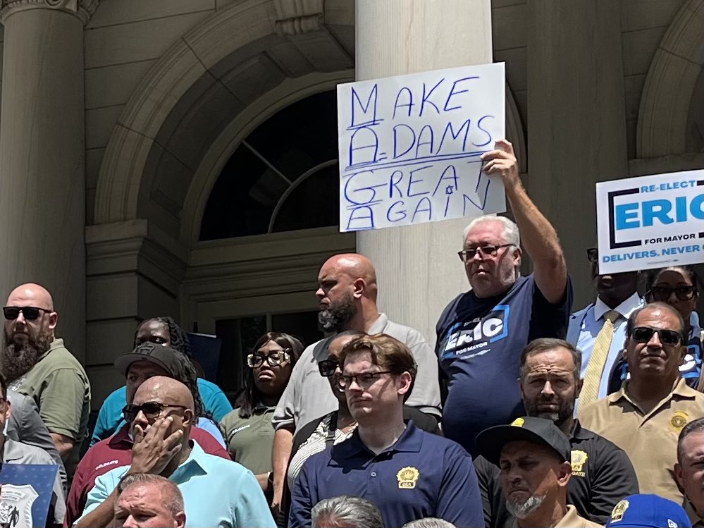 JosieStratman's tweet image. Among the rank-and-file supporters at a endorsement rally for Mayor Adams on the steps of City Hall:
- man with a “Make Adams great again” sign
- man with a “Mamdani is bad for NYC” sign wearing a hat promoting his Santa-for-hire business