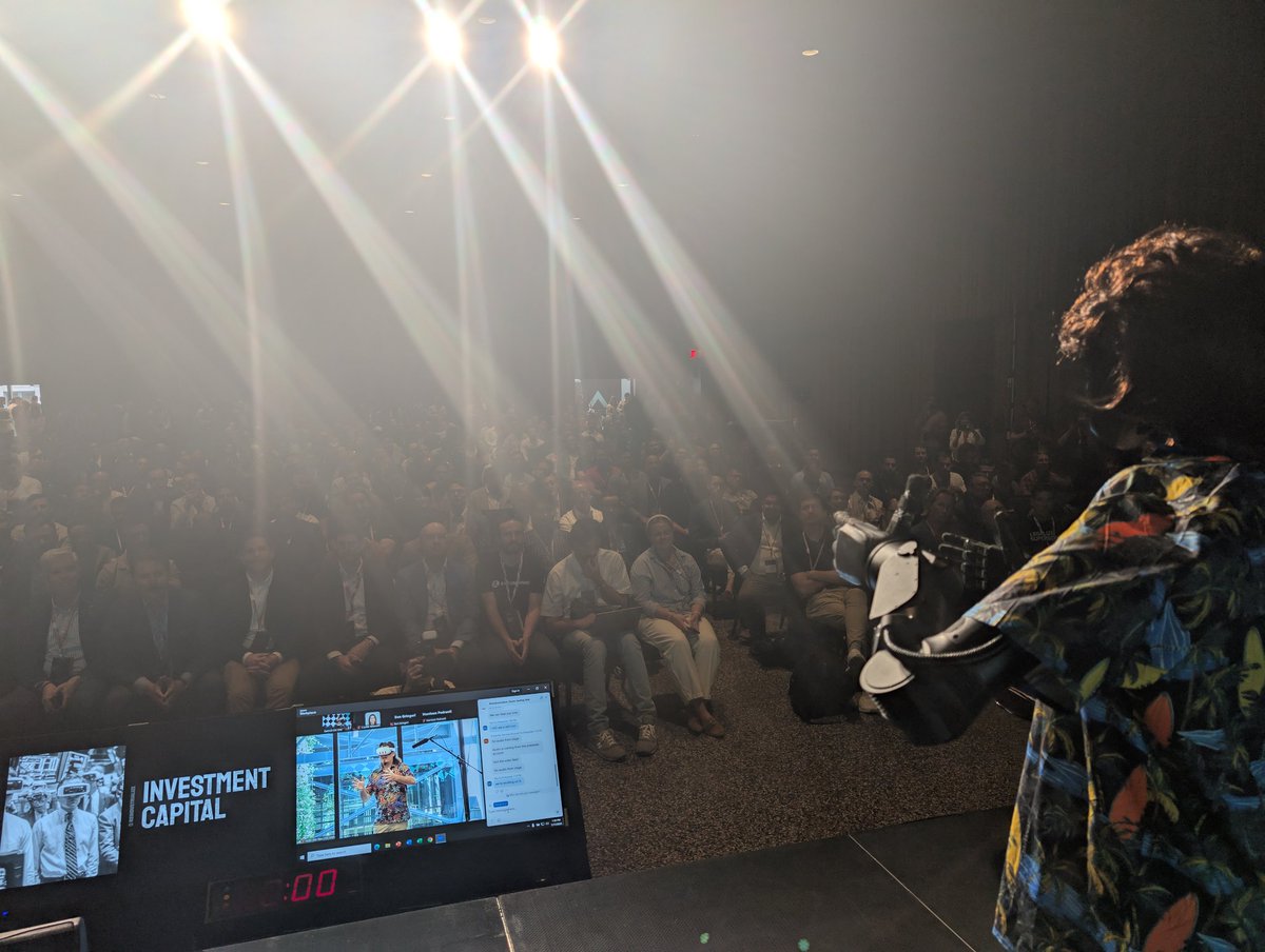 ashleevance's tweet image. From the stage with robot @PalmerLuckey at @reindsummit