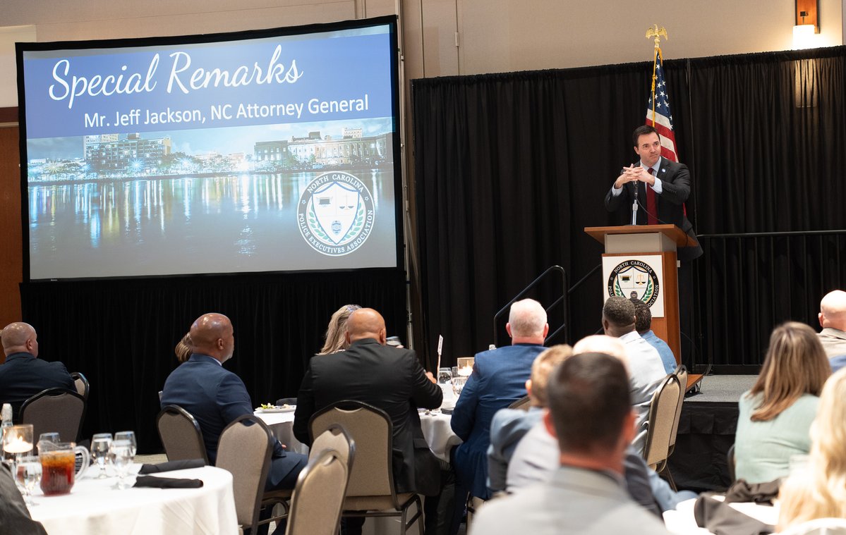 NCAGO's tweet image. This week, Attorney General @JeffJacksonNC spoke at the North Carolina Police Executives Association's annual summer conference in Wilmington, discussing NCDOJ's work to support law enforcement and protect North Carolinians from scams and fraud.