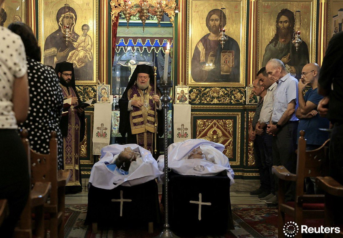 idreesali114's tweet image. Archbishop Alexios stands in front of the bodies of Palestinian Christians Saad Salama and Foumia Ayyad, who were killed in an Israeli strike on the Holy Family Church, according to medics, in Gaza City, July 17, 2025. REUTERS/Dawoud Abu Alkas