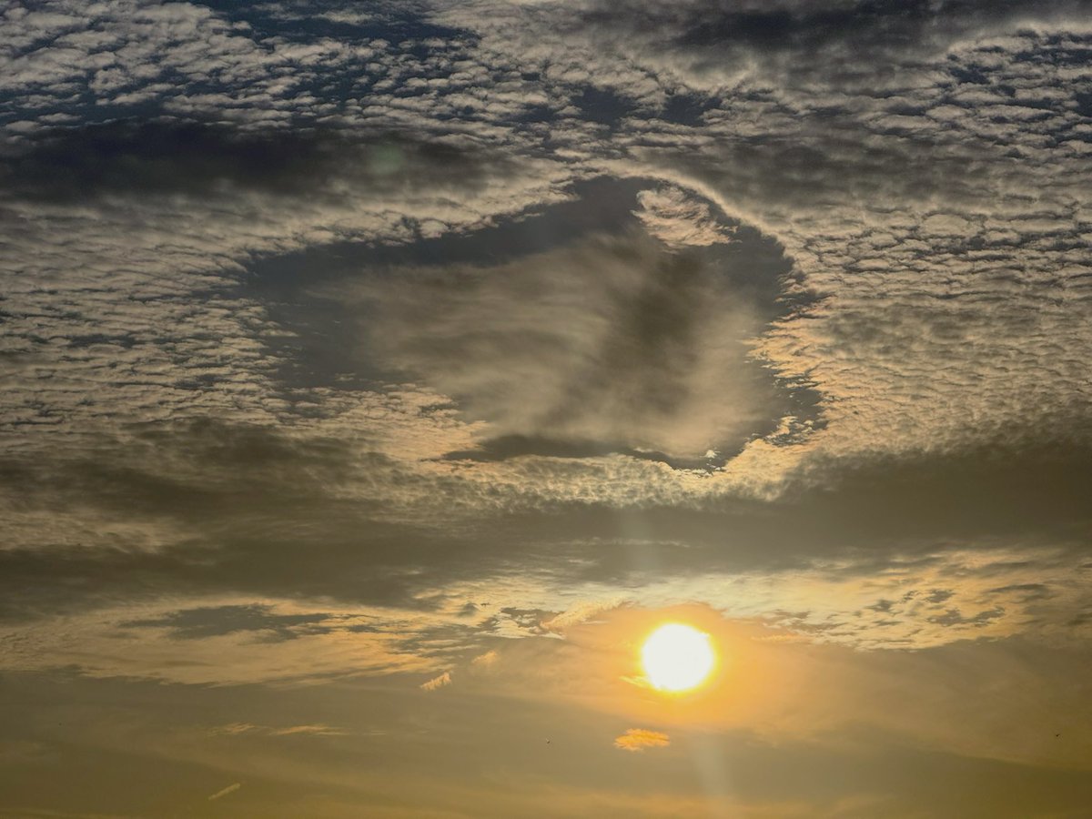 Wow! Looks like we caught a fallstreak hole in Jonesboro, AR just moments ago. 

A fallstreak hole, also known as a hole punch cloud, is a circular or elliptical gap that can appear in cirrocumulus or altocumulus clouds. These holes form when supercooled water droplets in the