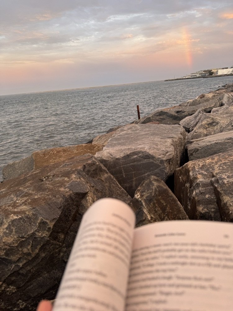 Ms. Gregg is reading!  Check out her view - beach, sunset and even a rainbow! Where are you reading this summer? #ParkPRIDE #BelongGrowSucceed #SummerReading