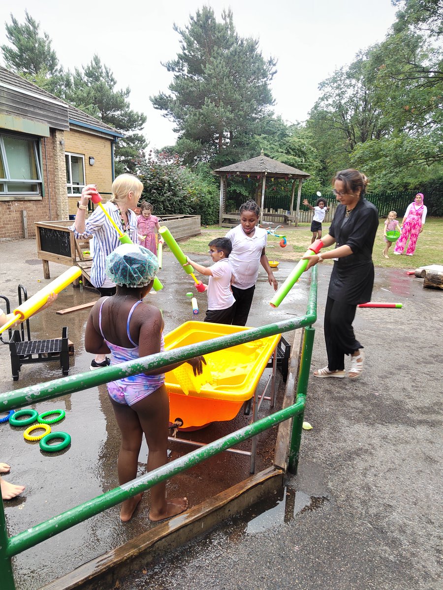 Our children in "The Dell" engaged in water play yesterday. They laughed loudly as they splashed in the cool water and delighted in squirting the staff with water guns.