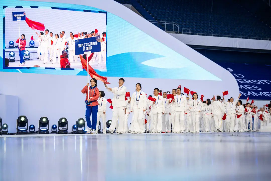 Proud moment for HUST! Liu Bei from Huazhong University of Science and Technology leads Team China 🇨🇳 as flag bearer at the FISU World University Games in Germany. She's eyeing gold medal in 3x3 basketball!