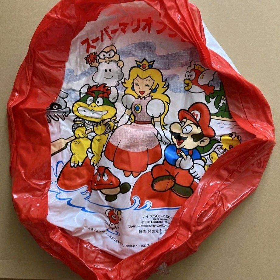TheUltiMarioFan's tweet image. Official Super Mario Bros. 1988 inflatable, featuring Mario and Bowser paddling a toadie float to transport Princess Peach across the ocean.