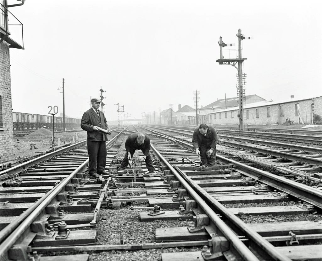 TrainStations23's tweet image. Fixing points at Coldham Lane signal box, Cambridge, 12 March 1963. 

SSPL
