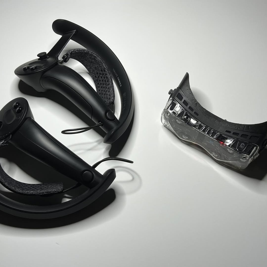 BigscreenVR's tweet image. Prototypes from 2021/2022 sitting next to the Valve Index controllers