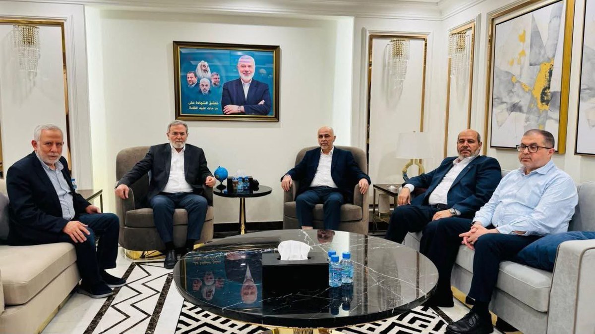 ezzingaza's tweet image. They sit beneath crystal chandeliers, wrapped in silence too pristine to be innocent.
Five men. Clean hands. Full bellies. Expensive watches gleaming beneath tailored sleeves.
They call themselves representatives.
But who appointed them?
Not the mothers digging graves with their…