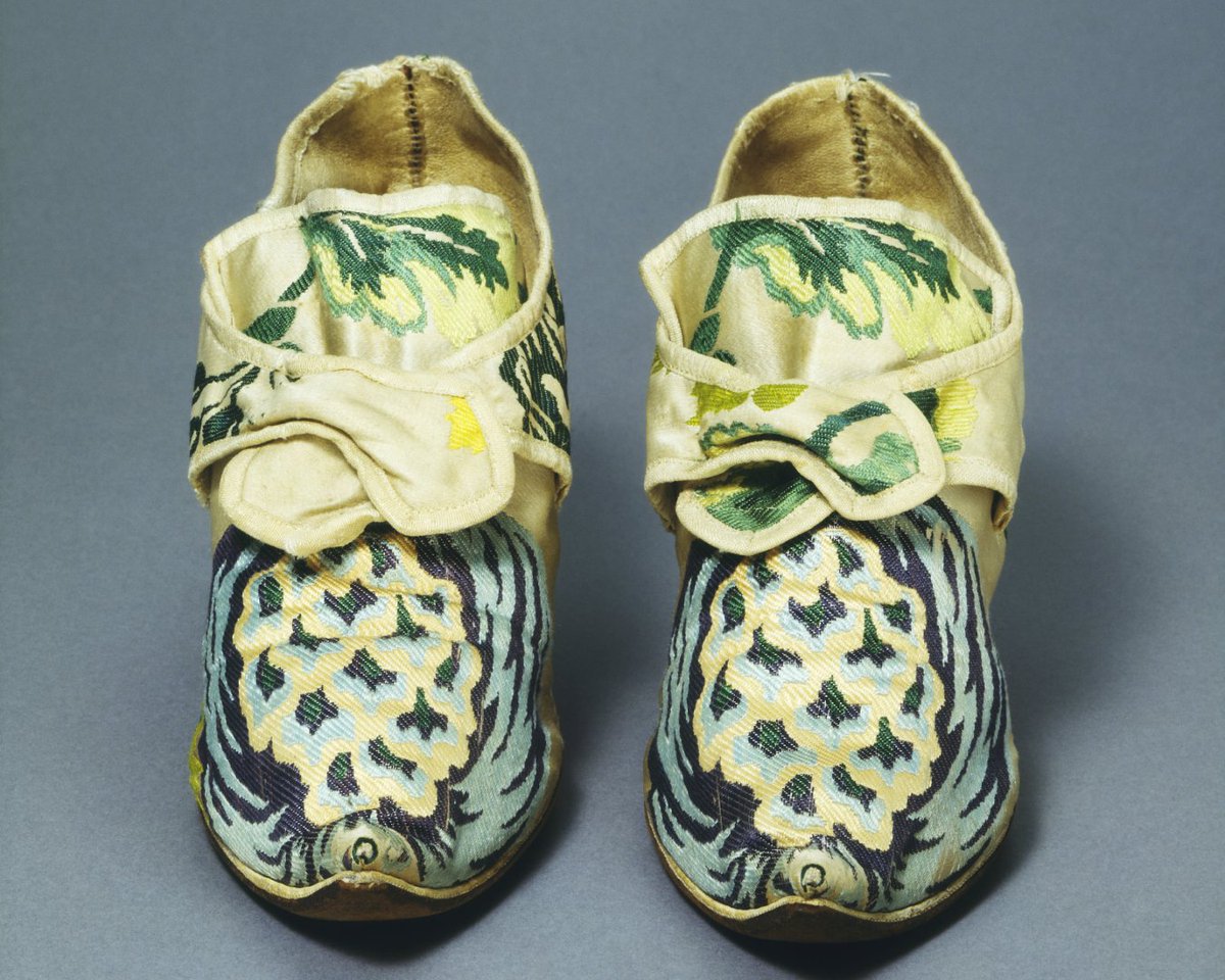 V_and_A's tweet image. Silk footwear in the 18th century reflected elegance and status. Women’s shoes featured curved heels, pointed toes, and silk uppers with detailed floral motifs. Intended for indoor use only, they fastened with cut steel buckles. Outdoor wear required practical leather boots.