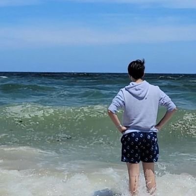 new year new me staring into the distance dramatically at the beach