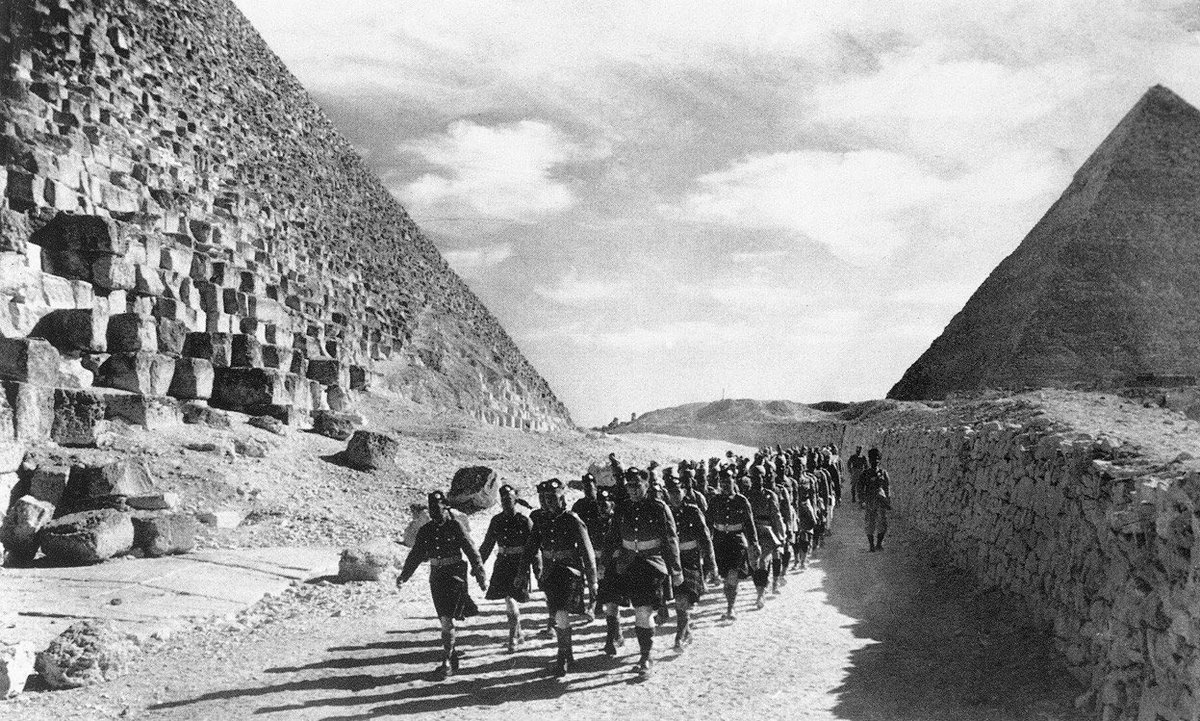 Empireaesth's tweet image. British Troops marching through the Great Pyramids of Egypt (1941)
