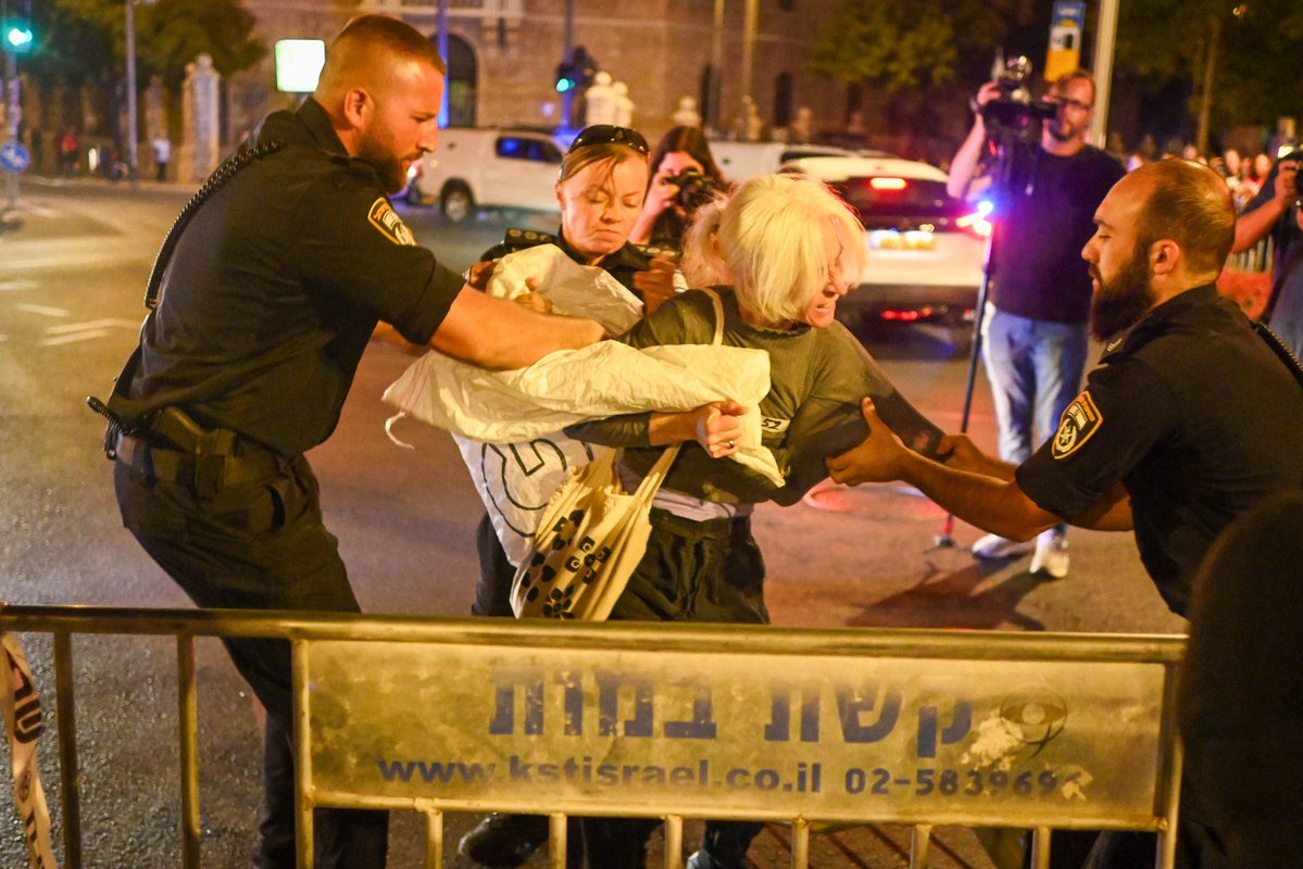 flom_jess's tweet image. Police violently confiscate a sign at a block against genocide in Jerusalem