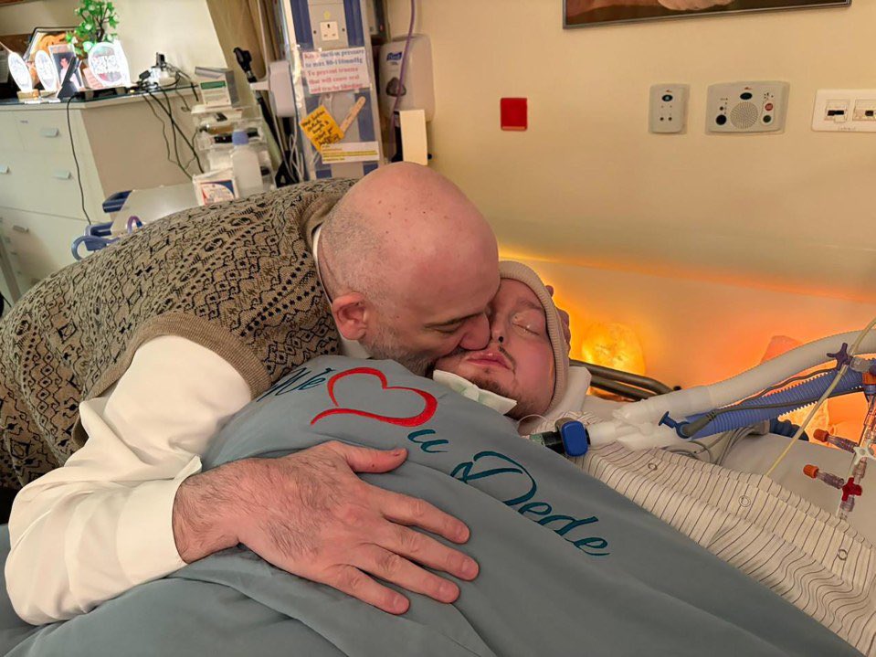 Prince Khaled bin Talal kisses his son Al-Waleed, the 'Sleeping Prince', during a hospital visit.