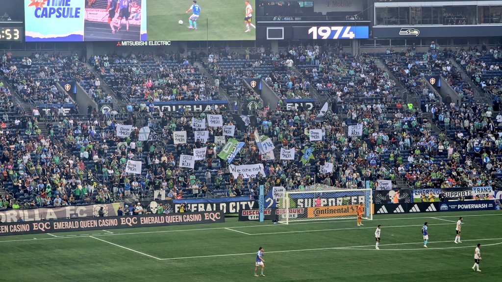 Tonight in Seattle: Sounders fans hold up signs that say, "Chinga La Migra" and "We Are Not All Here"