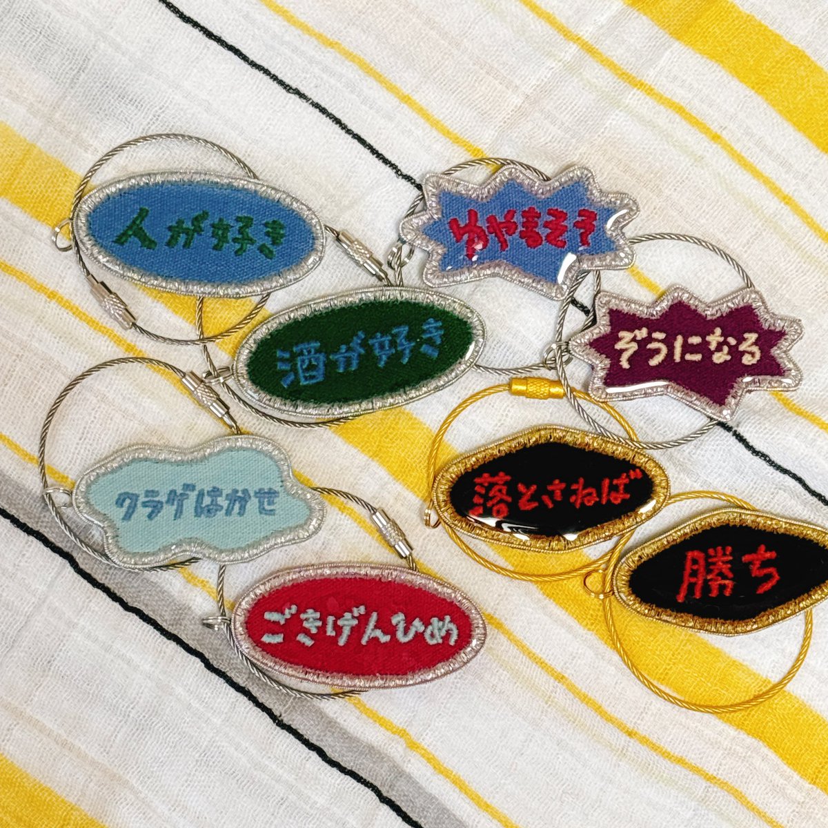 KOMATSUTB's tweet photo. 一気に届いて壮観🤣💯🤣💯🤣💯ありちゃんありがと〜。 @antsally_info どうしてもぶら下げて撮りたくて、物干し竿に吊るしてみた。かわいい…🥹新調したリュックにも、概念バングルの名前をつけてご満悦！いい夏！（韻踏んだ）（うるせえ） https://t.co/9m18qJBHvs