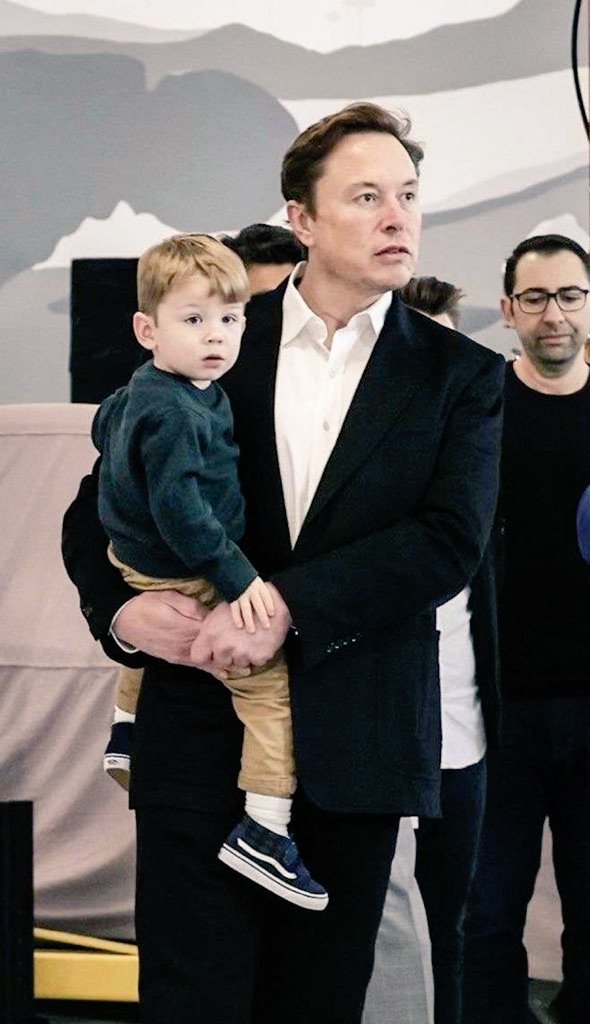 "A man building the world, holding his own little world in his arms. 🌍👶"